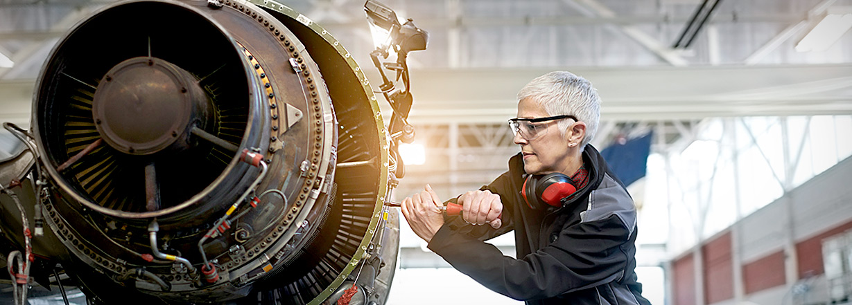  Image of technician working on aircraft engine.